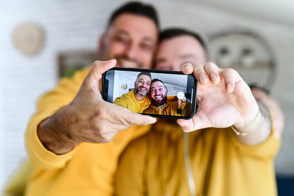 Men smiling taking a selfie