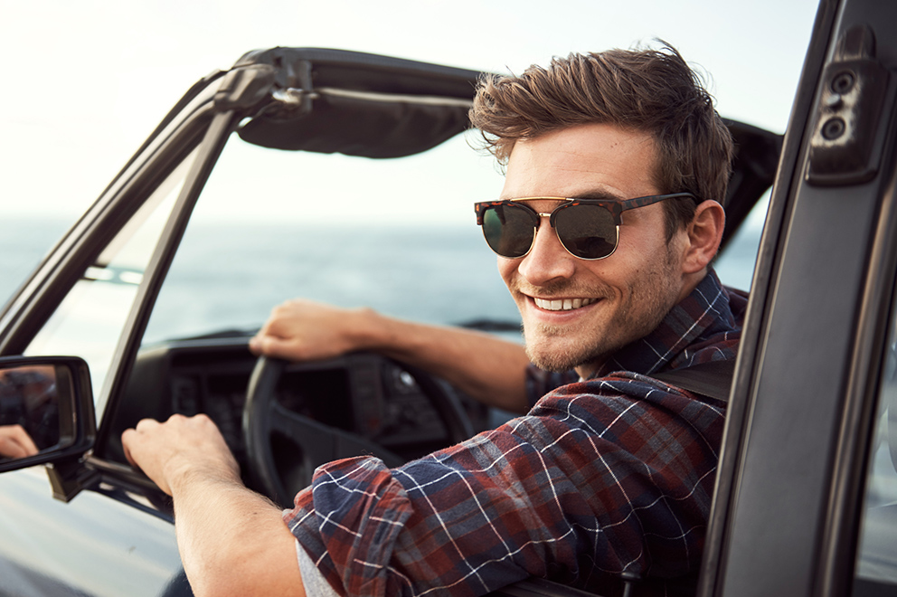 Man smiling in car