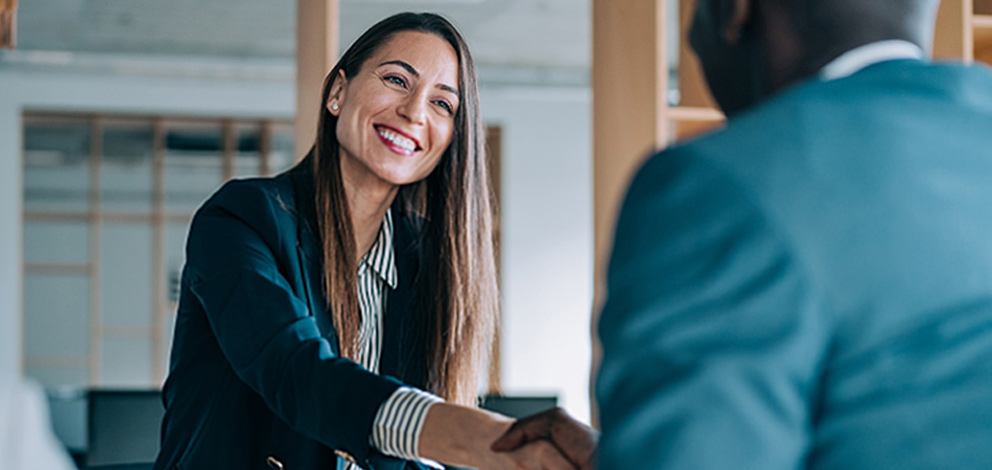 Woman smiling shaking hands