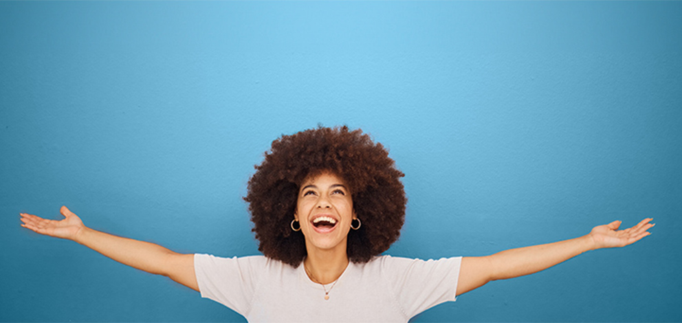 Woman smiling with arms open wide