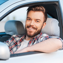 Man smiling in car