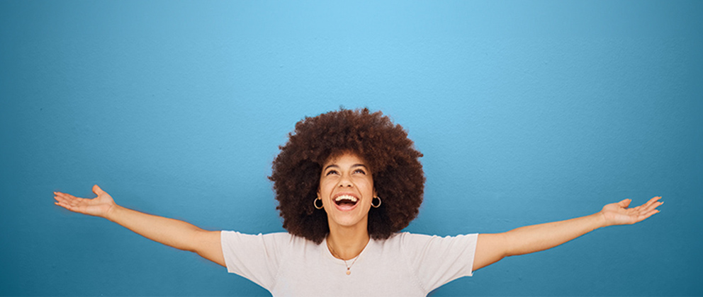 Woman smiling with arms open wide