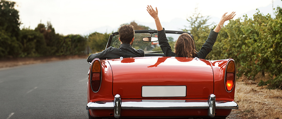 couple driving away in car