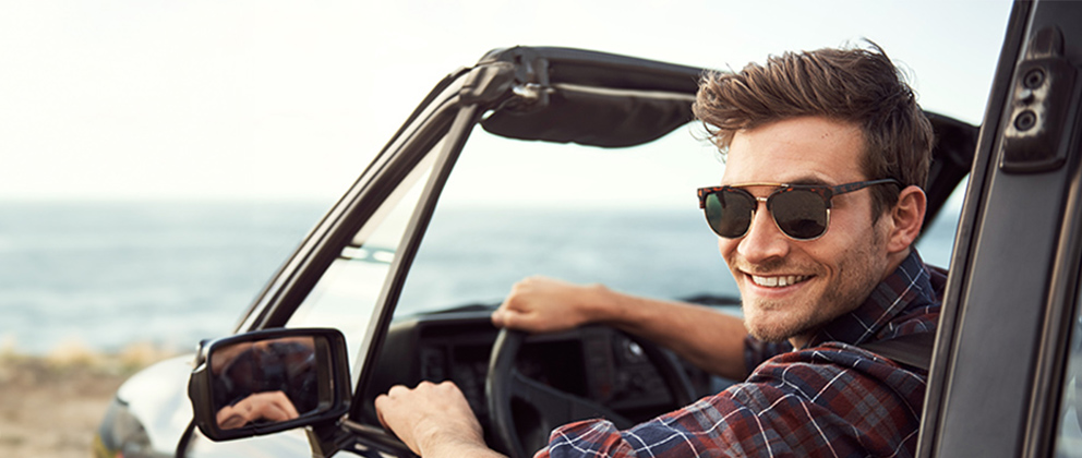 man smiling in car